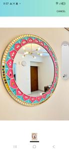 a mirror with a colorful design on a wall at Hotel KK palace in Chittaurgarh