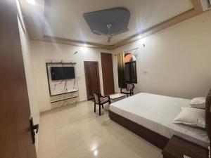 a hotel room with a bed and a tv at Hotel KK palace in Chittaurgarh
