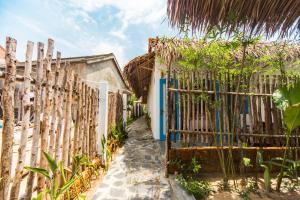 a gate to a house with a fence at Cashew Tree Bungalow in Hoi An