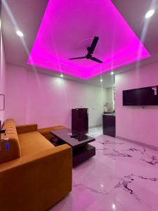 a living room with a couch and a pink ceiling at Cabana suites in Rishīkesh
