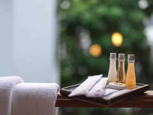 three bottles of beer on a tray on a table at Lanna Tree Boutique Hotel in Chiang Mai