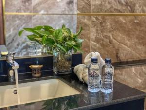 two bottles of water sitting on a counter next to a sink at Lanna Tree Boutique Hotel in Chiang Mai +35 photos