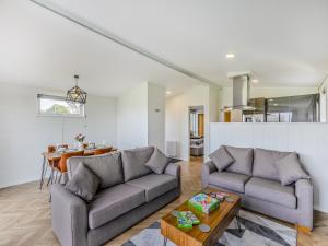 a living room with two couches and a table at Billy Goat Lodge in Crossway Green