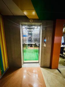 a hallway with a window in a room at Hotel Sarbick International in Kukrāil