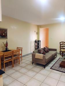 a living room with a couch and a table at Casa Rosa in Nanyuki