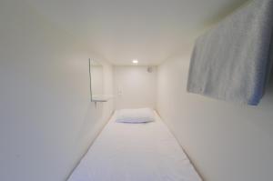 
Кровать или кровати в номере Капсульный Отель Интеркуб Большая Полянка
