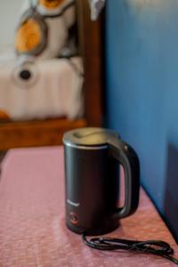 a black coffee cup sitting on a table at Diyana Cottage in Sigiriya