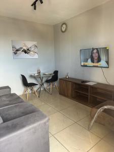 a living room with a tv on a wall at AP inteiro no Brás lado igrejas e comércio andar alto Estacionamento a combinar in São Paulo