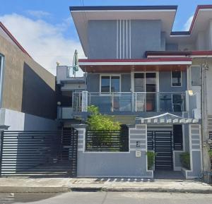 a grey house with a staircase leading to it at Cai Residence - Stylish 2BR Staycation near EK & Tagaytay Gateway in Santa Rosa