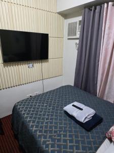 a hotel room with a bed with a towel on it at nicecondotel in Manila