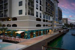 a building with a restaurant next to a body of water at Courtyard by Marriott Clearwater Beach in Clearwater Beach