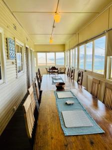 a dining room with a long table and chairs at Bermagui Bay Beach House 2, Wonderful Beachside Location, Pet Friendly in Bermagui