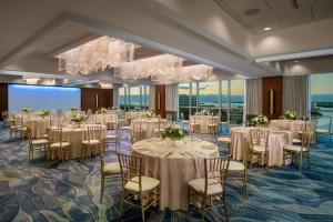 a banquet room with tables and chairs and a chandelier at The Westin Tampa Bay in Tampa