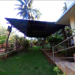 a covering on the side of a house at Homestay, Villa in Diveagar in Diveagar