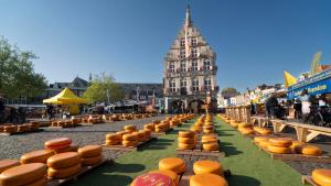 a street filled with lots of orange bowls on benches at Studio De Gravin in Gouda