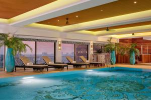 a swimming pool in a hotel room with a view at Le Meridien Al Khobar in Al Khobar