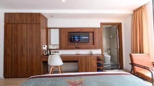 a hotel room with a bed and a bathroom at Simon Hotel in Nha Trang
