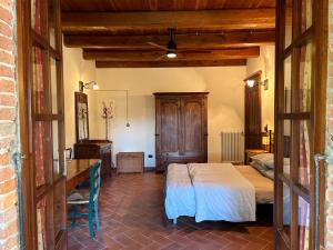 a bedroom with a bed and a desk in a room at Casa Ambrogina in Agliano Terme +38 photos