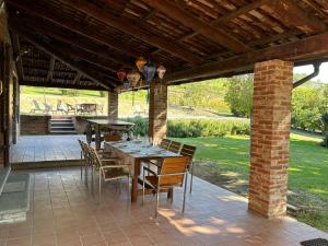 a patio with a table and chairs under a pavilion at Casa Ambrogina in Agliano Terme