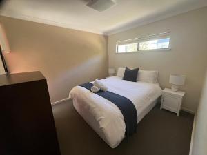 a bedroom with a bed with a teddy bear on it at 2 bed self-contained Beach Shack in Preston Beach +36 photos