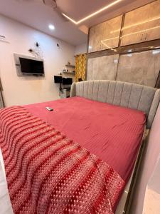 a bed in a room with a red blanket at Chill Vibes in Visakhapatnam +4 photos