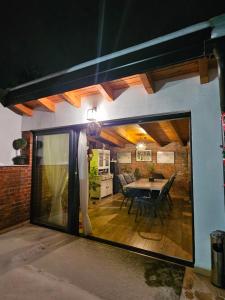 a large glass window of a living room with a table at Apartman Relax in Đakovo