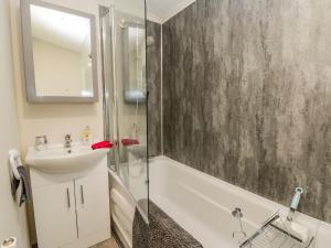 a bathroom with a shower and a sink and a bath tub at Happy Daze in Bridlington +10 photos