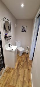 a bathroom with a white sink and a toilet at CeolMara in Ullapool +12 photos