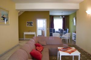 a living room with a couch and a table at Country Club La Mesteceni in Sebeş