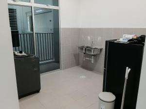 a bathroom with a shower and a sink and a toilet at D'Tarbiyyah Homestay in Labu