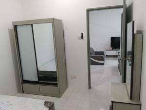 a room with two sliding glass doors and a living room at D'Tarbiyyah Homestay in Labu