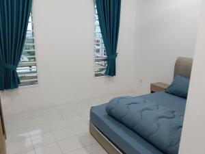 a bedroom with a blue bed and two windows at D'Tarbiyyah Homestay in Labu +8 photos