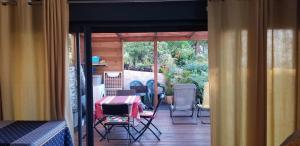a patio with a table and chairs on a porch at Chez Gigi in Petite Île +33 photos