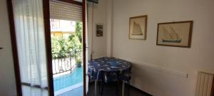 a table in a room with a balcony with a tableablish at nonna flo in Monterosso al Mare +11 photos