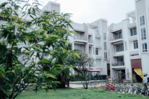 a man walks past an apartment building at Capetown Shaadows in Igatpuri