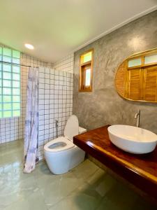 a bathroom with a sink and a toilet in it at Latehouse bar Amphawa in Amphawa +51 photos