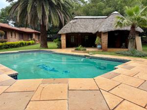 a swimming pool in front of a house at Pazuri Homestay in Kempton Park