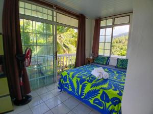 a bedroom with a bed with towels on it at Hiva Oa Villa Lodge in Hiva Oa