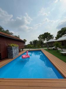 a swimming pool with a pink float in the middle at Melalueca tây ninh in Tây Ninh