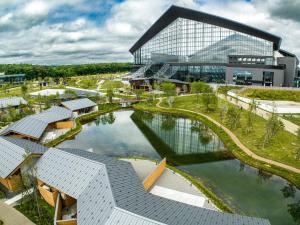 an aerial view of a building with a pond at ヴィラブラマーレ in Kitahiroshima