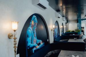 a room with a picture of a statue on the wall at Capetown Shaadows in Igatpuri