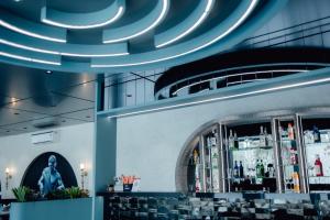 a bar with blue lights on the ceiling at Capetown Shaadows in Igatpuri
