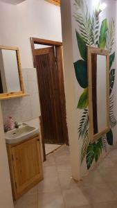 a bathroom with a sink and a mirror at Kabila moja hostel in Iringa