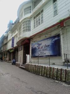 a building with a blue sign on the side of it at Hotel Best Inn in Darjeeling