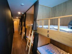 a group of bunk beds in a room at A Lucky Hostel in Hakuba