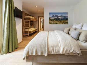 a bedroom with a bed and bunk beds at Kramerl in Bruck an der Großglocknerstraße