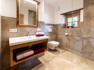 a bathroom with a sink and a toilet at Kramerl in Bruck an der Großglocknerstraße +49 photos