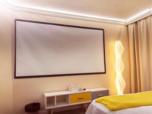 a large projection screen on the wall of a bedroom at Maizi Apartment Homestay, Shanghai in Shanghai +87 photos