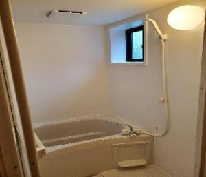 a bathroom with a tub and a toilet and a window at Costa Hinase Resort in Kakui-jima +9 photos