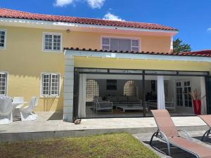 a house with a conservatory with a patio at yalwa house in Sweet Valley +7 photos